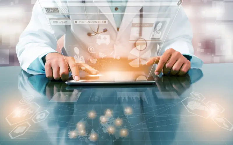 A clinician works on a tablet with glowing medical icons rising from the screen.
